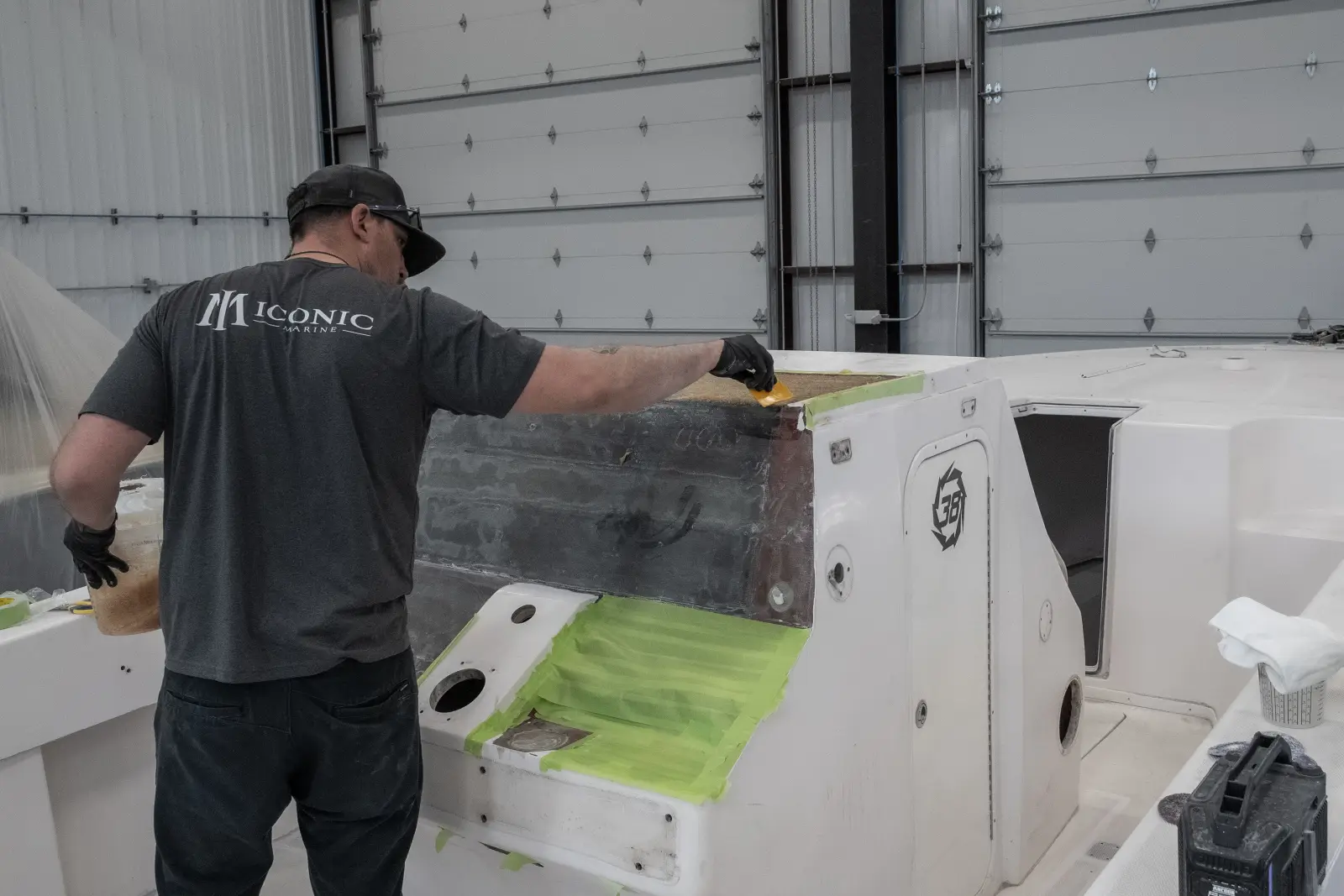 A Big Thunder Marine technician working on a fiberglass repair